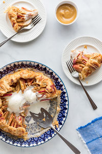 Salted caramel apple galette topped with vanilla ice cream and plated servings.