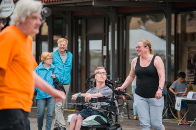 Friends standing on bicycle