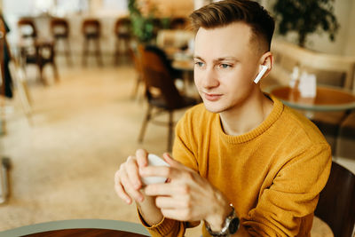 Portrait of young man holding camera