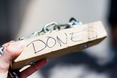 Close-up of hand holding text