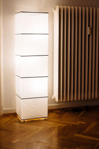 Illuminated lighting equipment on hardwood floor at home