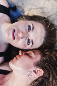 Portrait of woman sleeping with friend at beach