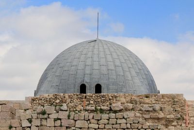 Low angle view of historical building against cloudy sky