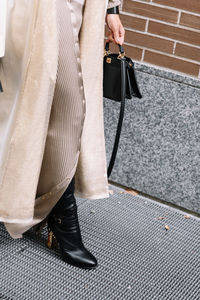 Low section of woman standing on street