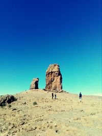 Rock formations in desert against blue sky