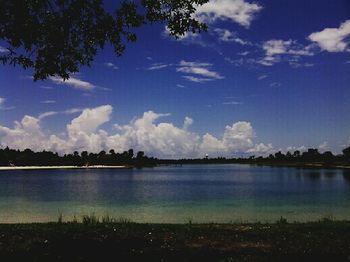 Scenic shot of calm lake against cloudy sky