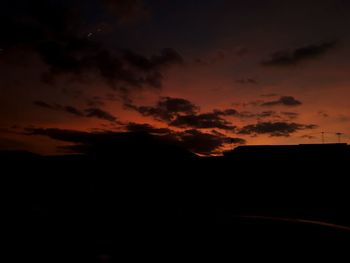 Silhouette landscape against sky at sunset
