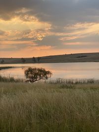 Scenic view of lake against sky during sunset