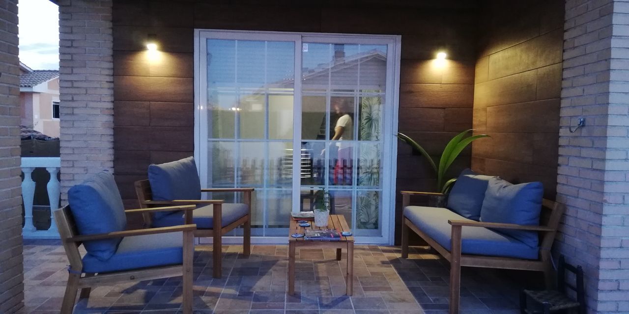 CHAIRS AND TABLES IN GLASS WINDOW