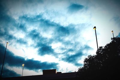 Low angle view of silhouette flag against sky