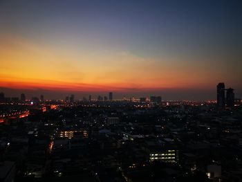 High angle view of illuminated buildings against sky during sunset
