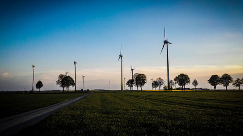 Low angle view of wind turbine against cloudy sky