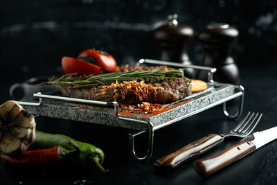 Close-up of meat in cooking pan on table