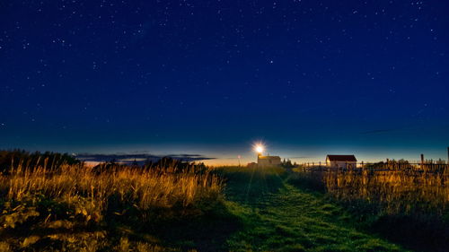 Scenic view of field against sky at night