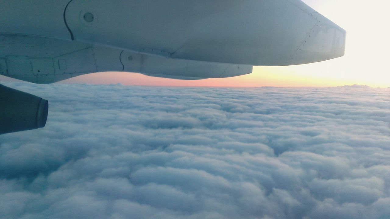 sky, airplane, cloud - sky, air vehicle, flying, aerial view, transportation, aircraft wing, mode of transport, travel, scenics, beauty in nature, building exterior, cloudscape, nature, cloud, part of, weather, mid-air, sunset