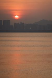 Scenic view of sea against orange sky