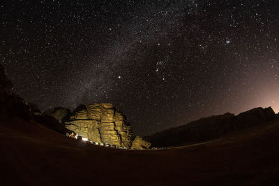 Scenic view of mountains against sky at night