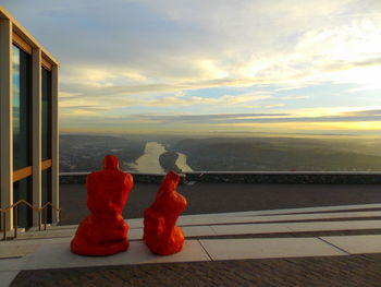 Close-up of red fire hydrant against sky during sunset