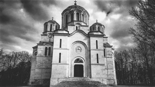 Low angle view of church against cloudy sky