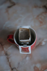 Top view of coffee being brewed in filter bag at home, alternative coffee drink