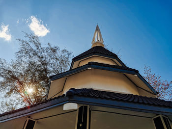 Low angle view of building and trees against sky