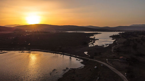 Scenic view of lake against sky during sunset
