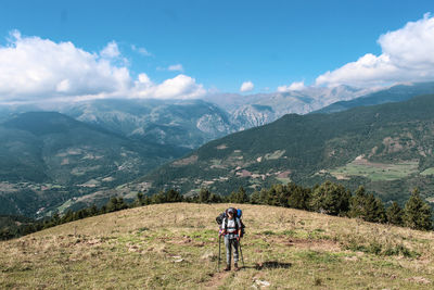 Full length of woman standing on field against landscape