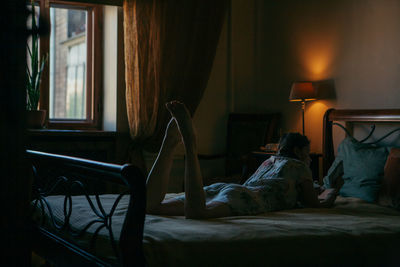 Woman relaxing on bed at home