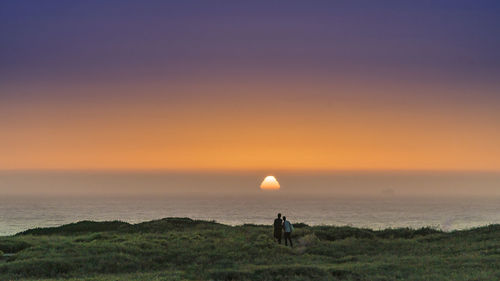 Scenic view of sea against clear sky during sunset