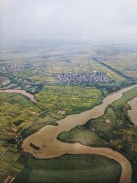 Aerial view of agricultural field against sky