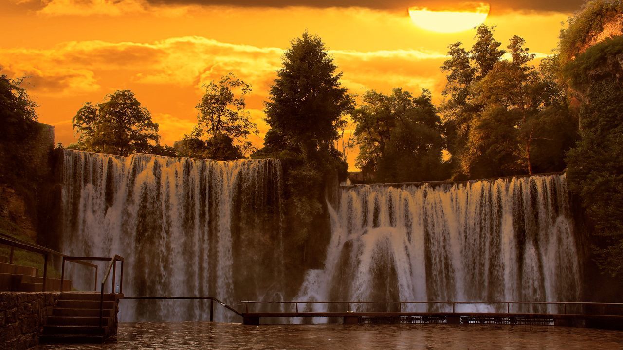 SCENIC VIEW OF WATERFALL DURING SUNSET