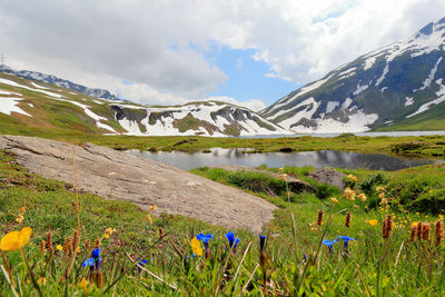 Scenic view of lake and mountains against sky