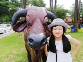 Portrait of woman wearing hat standing outdoors