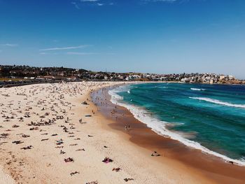 People enjoying summer at beach against sky