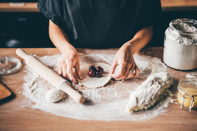 Midsection of man preparing food on table