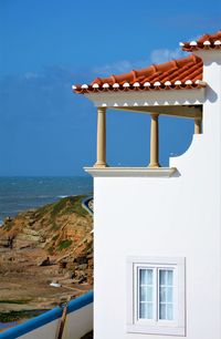 Close-up of built structure by sea against sky