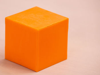 Close-up of orange on table against white background