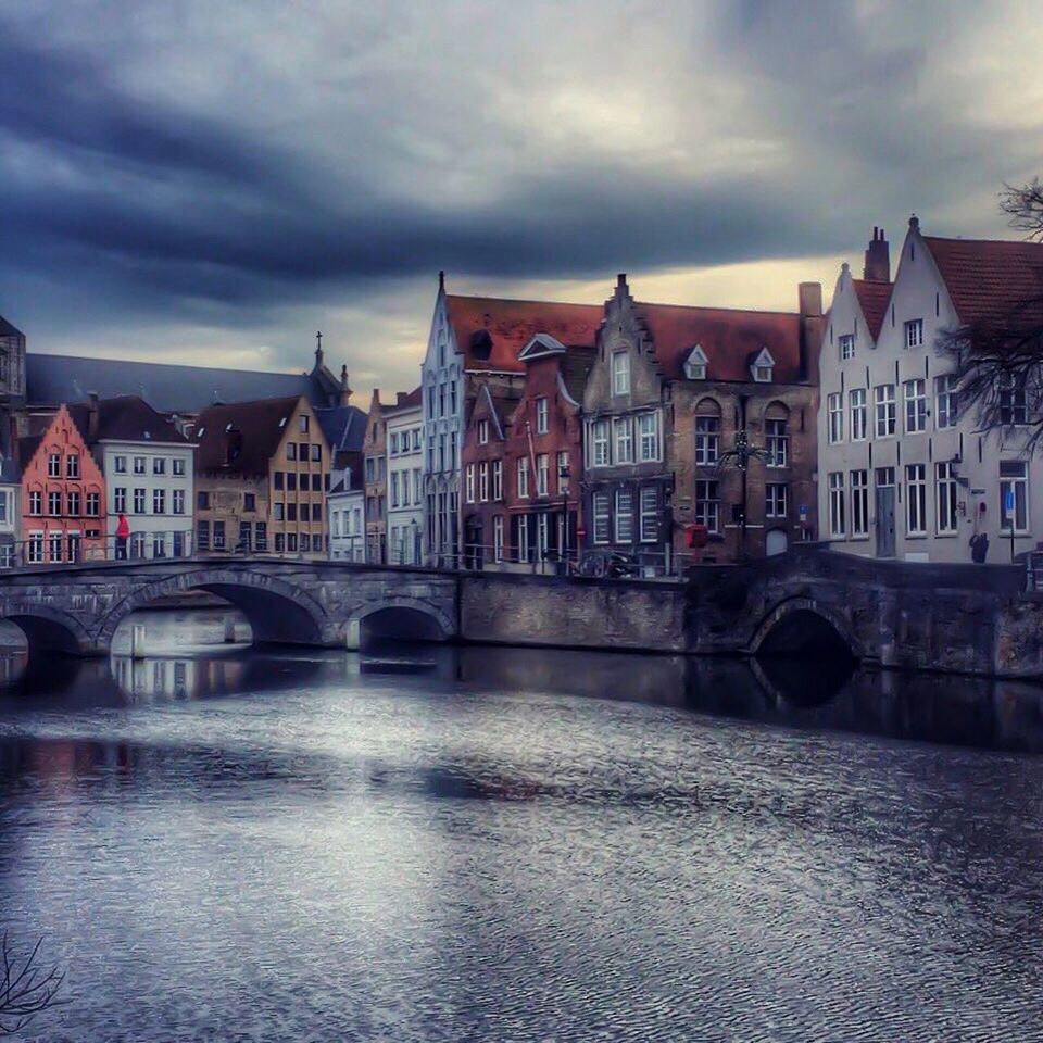 architecture, built structure, building exterior, sky, water, cloud - sky, waterfront, cloudy, arch, city, river, cloud, reflection, canal, building, residential structure, residential building, travel destinations, facade, outdoors