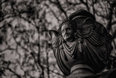 Low angle view of angel statue against sky