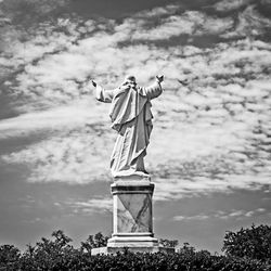 Statue against cloudy sky