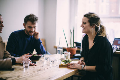 Young woman sitting at restaurant table