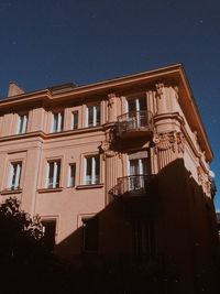 Low angle view of building against clear sky at night