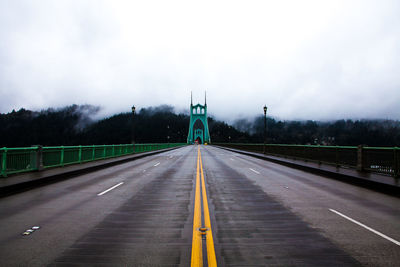 St johns bridge against sky during foggy weather