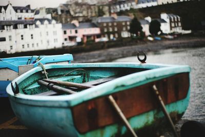 Close-up of abandoned boat moored in water