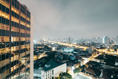 High angle view of illuminated buildings in city against sky