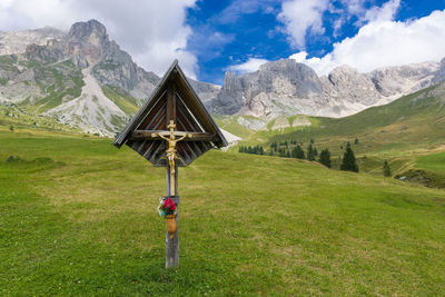 Cross on countryside landscape against the sky