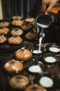 Close-up of person preparing food at market stall