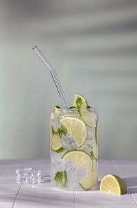 Glass of sparkling water with ice lime and mint 