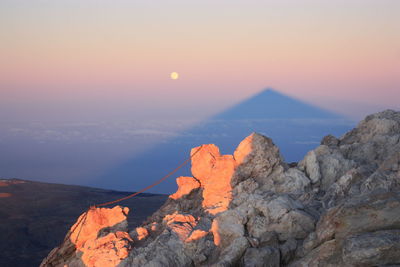 Scenic view of sea against orange sky