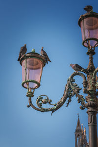Low angle view of statue against clear blue sky